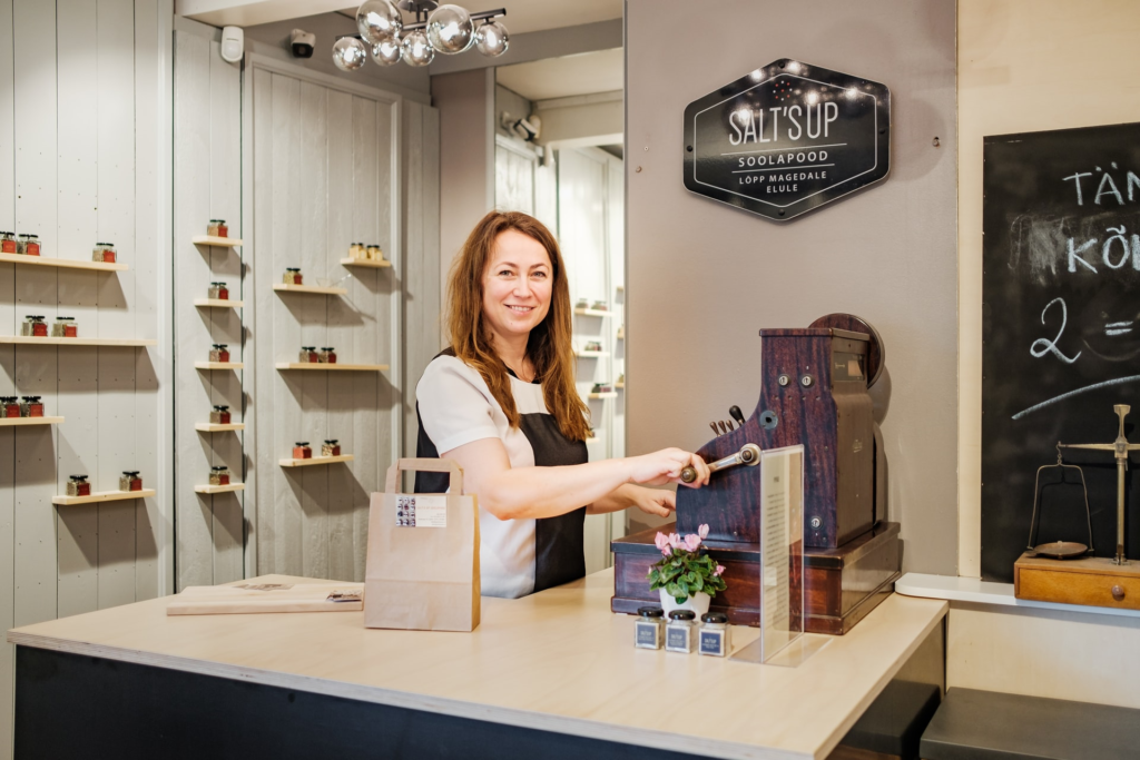 Woman business owner in a small gourmet shop